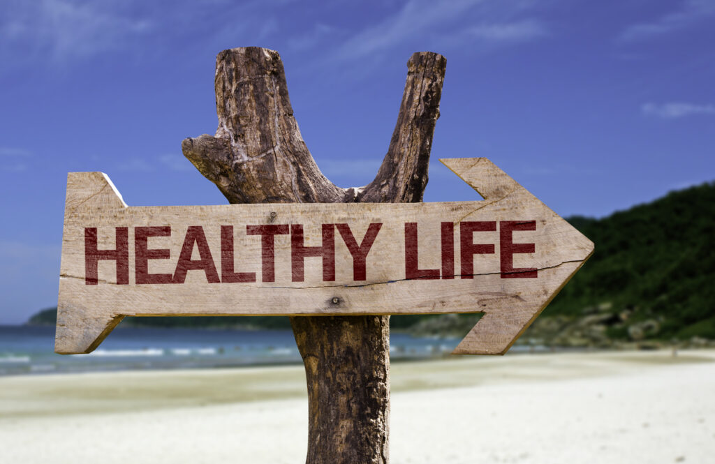 Sign on beach pointing to a healthy life through opiate withdrawal treatment